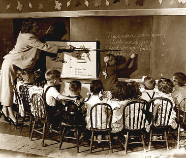 Aula antigua con niños aprendiendo frente a una pizarra de tiza negra